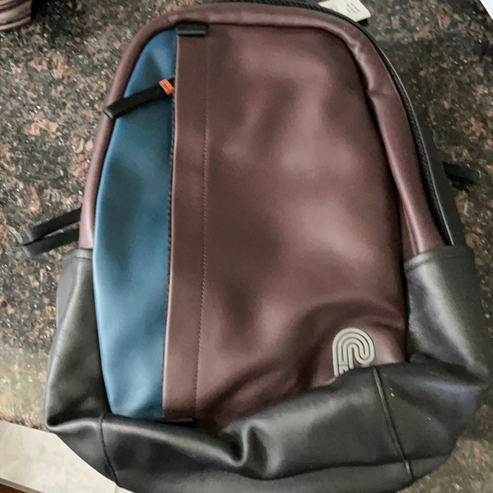 A Coach back pack brown & blue multiple pockets